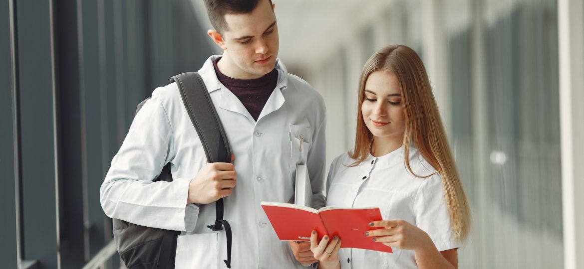 Medical students are reading a book in a hospital hall