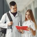 Medical students are reading a book in a hospital hall